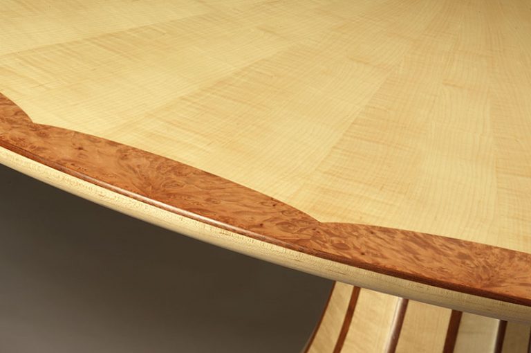 Circular table in ripple Maple veneer with burr Maple edge detail and Mahogany stringing